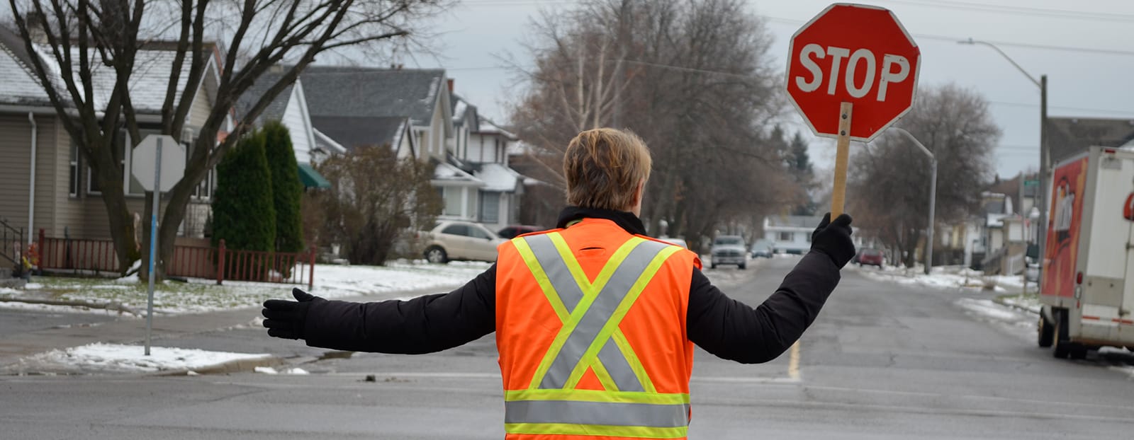 crossing guard holding stop sign