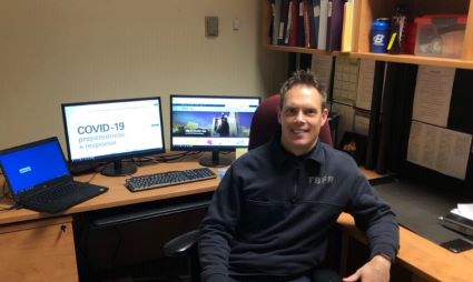 Brandon Smith sitting at his desk 