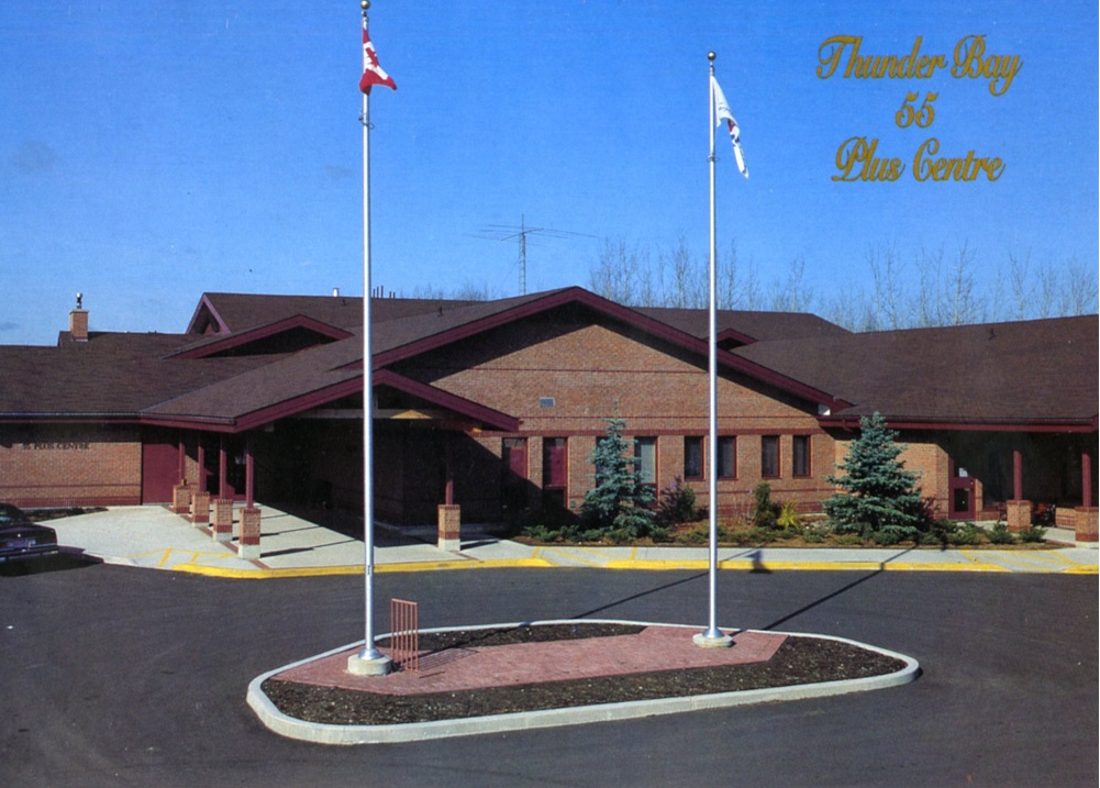 front of a building with two flag poles