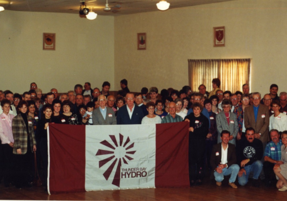 group photo with people holding Thunder Bay hydro flag