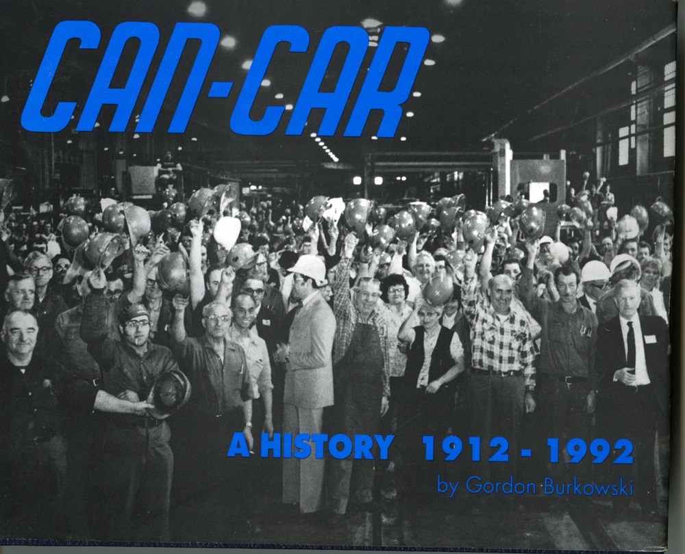 front of Can-Car History Book with large group of people