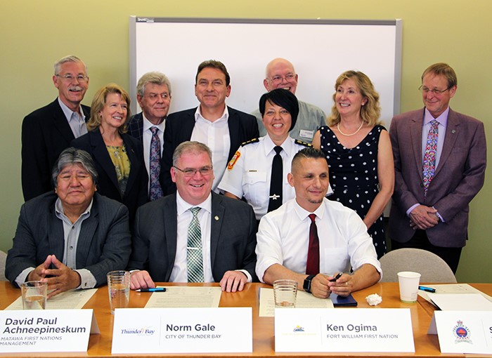 Signing of the Anti-Racism and Inclusion Accord with several people at a table