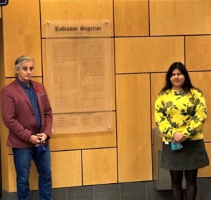 mayor and woman standing in front of treaty plaque