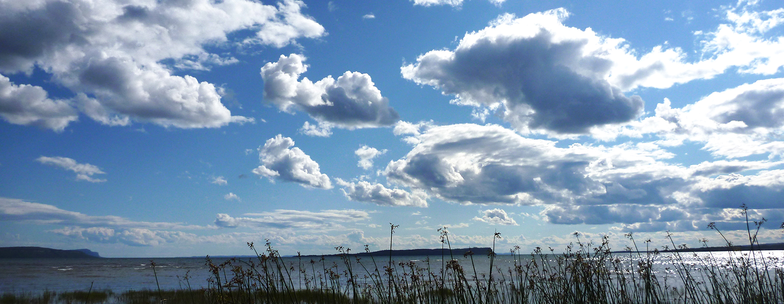 white clouds in sky over water