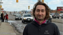 man smiling and standing on side of Memorial Avenue