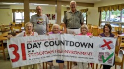 residents of pioneer ridge holding up sign that celebrates going styrofoam free