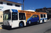 a passenger paying the driver as he walks onto the bus