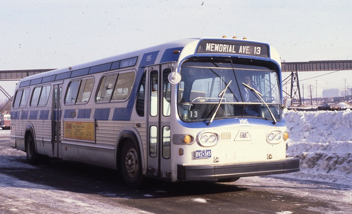a bus parked beside a snow bank. The front of the bus says, "Memorial Ave. 13"