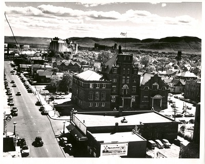 An aerial photo taken above city hall, cars and buildings are present