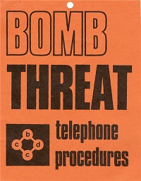 An orange poster with the words bomb threat in bold