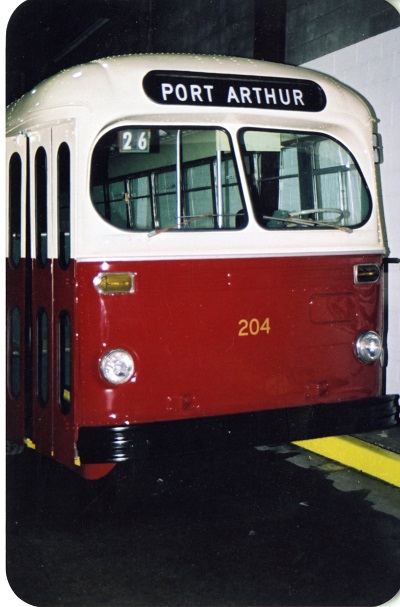 A red and white bus with a Port Arthur sign on the top