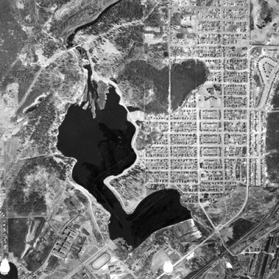 An aerial photo showing a large body of water surrounded by city streets