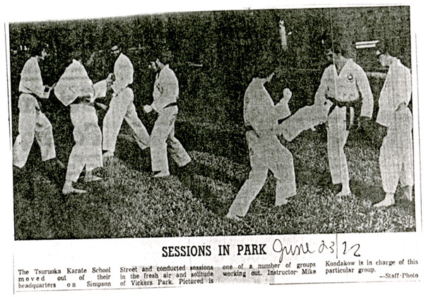 Adults dressed in Martial Arts gear practicing their moves