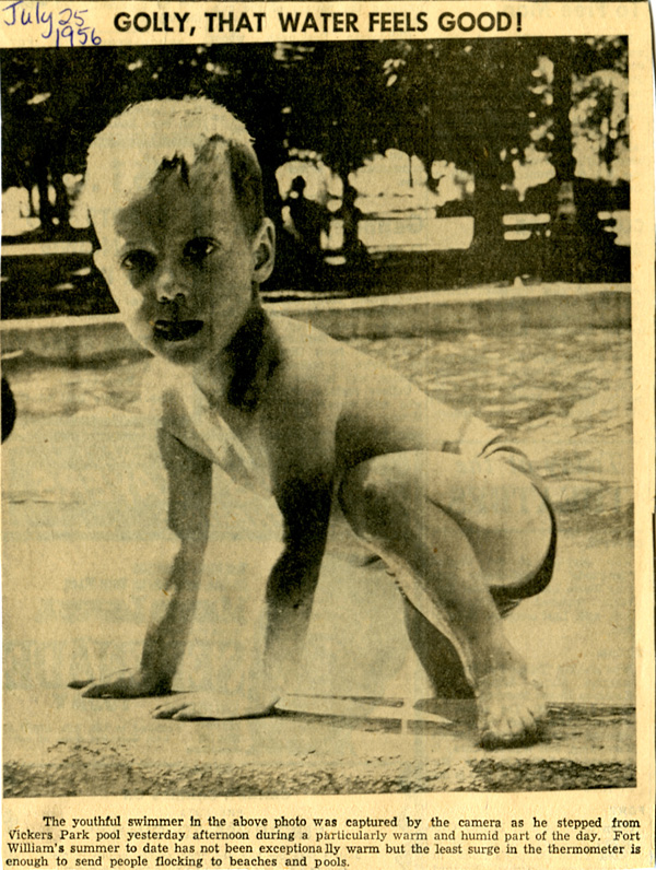 A newspaper clipping showing a child getting out of a pool