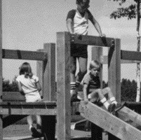 Children playing on a slide in a black and white photograph