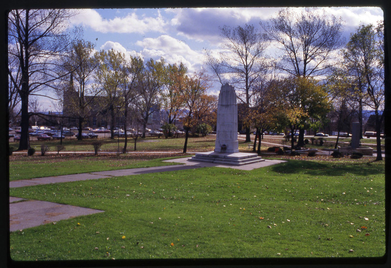 a large cenotaph among green grass and trees