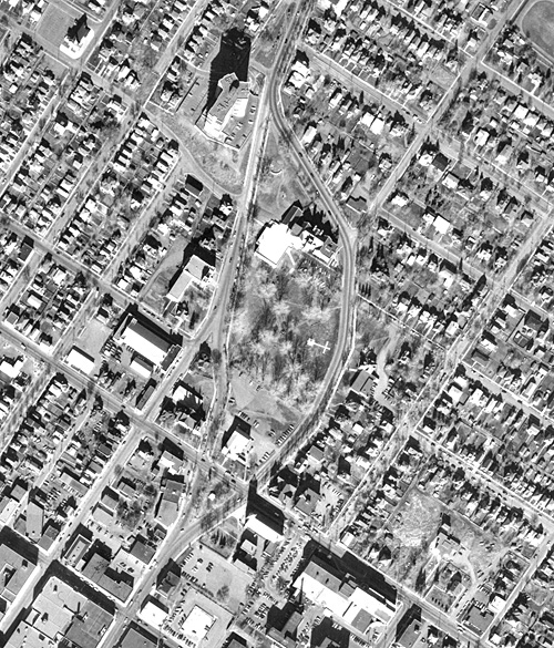 An aerial photograph taken over  a body of water and residental houses