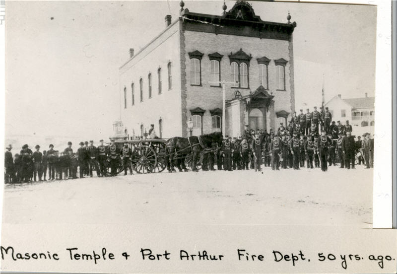 A group of firefighters standing in front of a building 