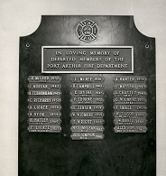 A wooden plaque with metal name plates detailing those who had been lost