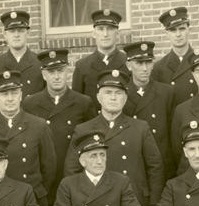 A group of men in firefighter uniforms sitting together 