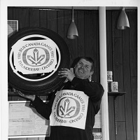 A man holding a branded tire with the Canada Games logo