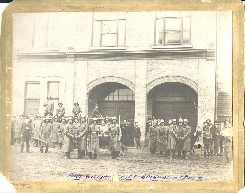 A group of firefighters standing out front of city hall 