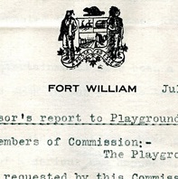 Two men stand beside a banner with a beaver on top, and the words Fort William underneath