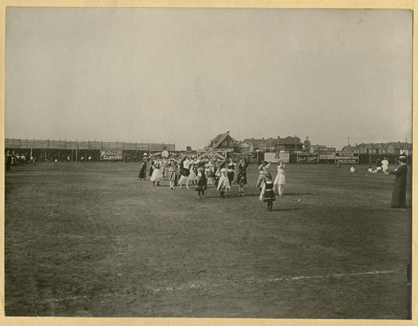 Girls in ethnic costumes dancing in field, at McKellar Park as part of the Playfest 