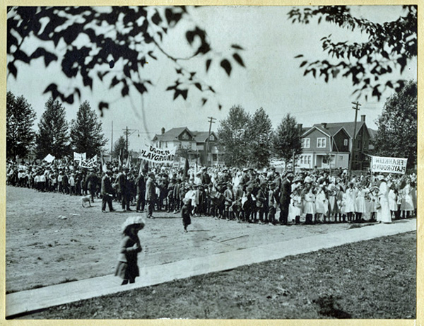 Parade of individuals from various playgrounds with various playground banners
