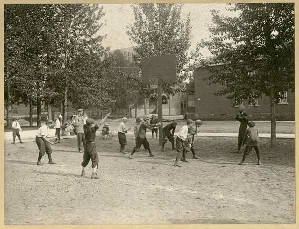 Boys playing basketball outdoors