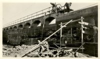 workers standing on a railway bridge 