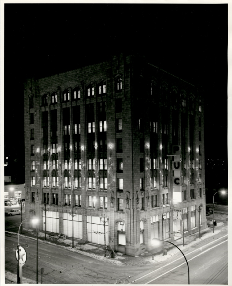 a large building at night and decorated for Christmas
