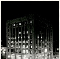 the building decorated for Christmas at night