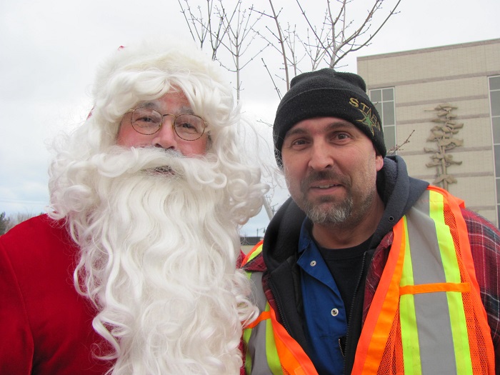 Santa and a man in an orange safety vest