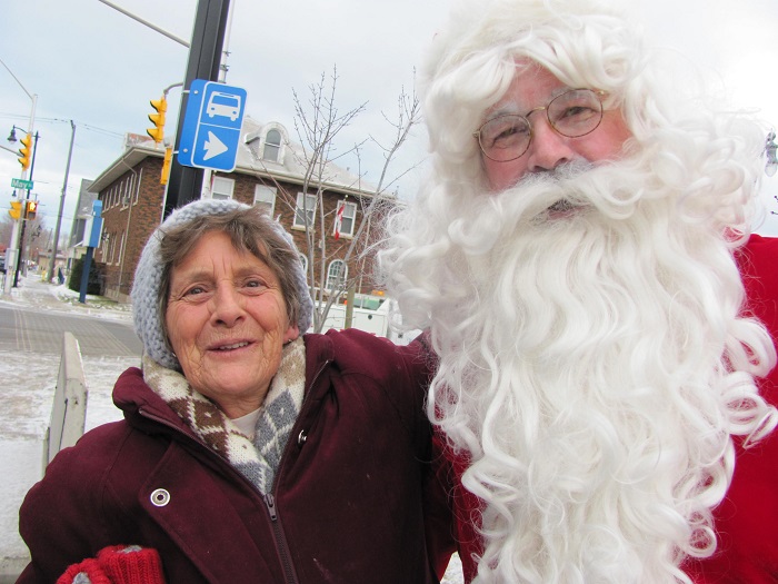 Santa and a woman wearing a hat and jacket