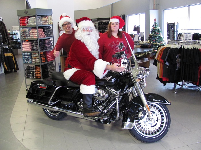 Santa sitting on a Harley Davidson motorcycle 