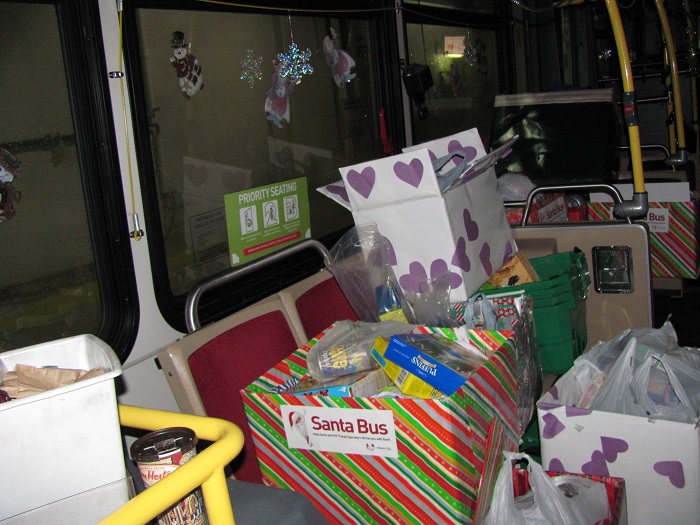 multiple full donation bins aboard the Santa Bus