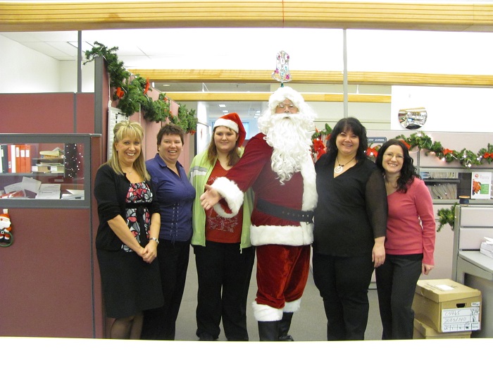 Santa with a group of city employees in an office