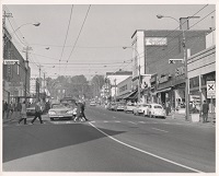 a street with buildings and cars with Town Hall in sight 