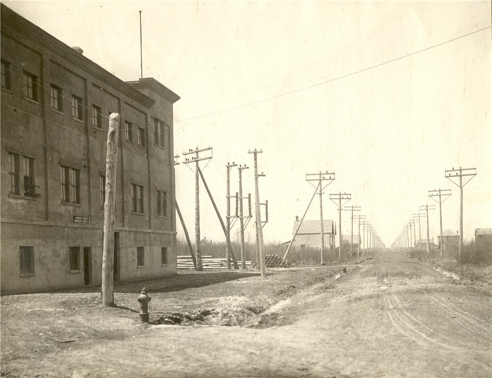 portion of building, houses and buildings down the street the building is on