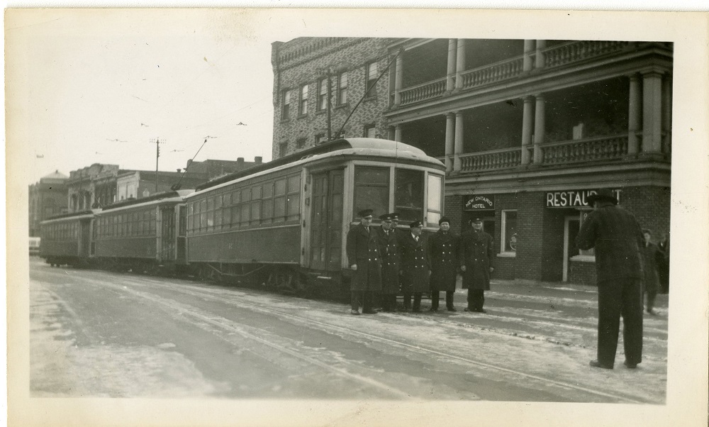 a group of operators as they pose in front of streetcars