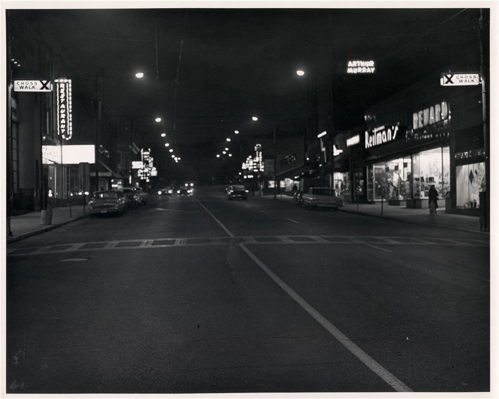 nighttime with an empty street with buildings along either side