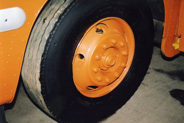 a bus wheel with an orange hubcap