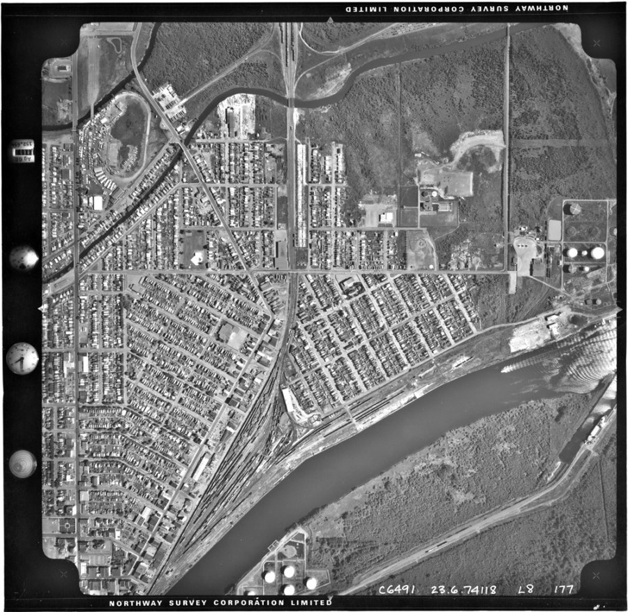 A black and white photo of the waterfront and surrounding residental area
