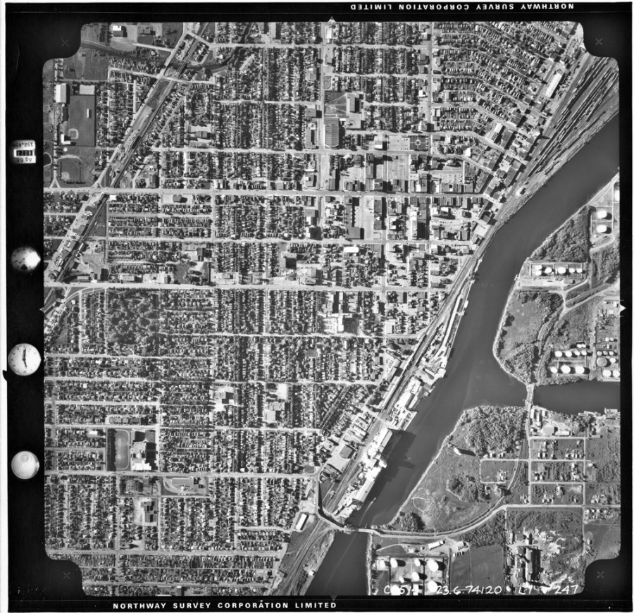 A black and white photo of the waterfront and surrounding residental area