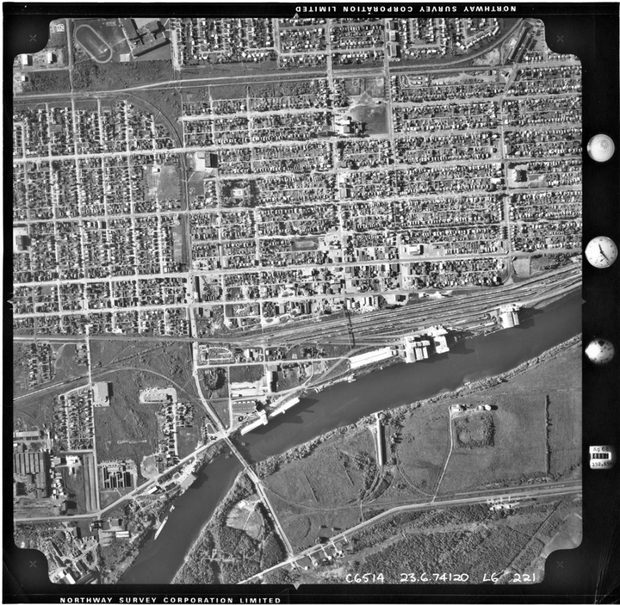 A black and white photo of the waterfront and surrounding residental area