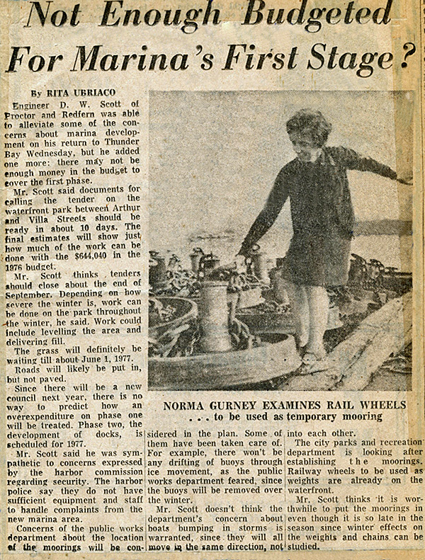 A newspaper article showing a woman walking along the waterfront