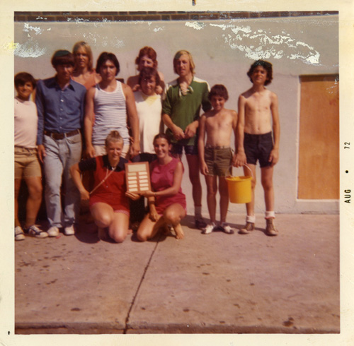 A group of men and women standing together and pose for a photogrpah