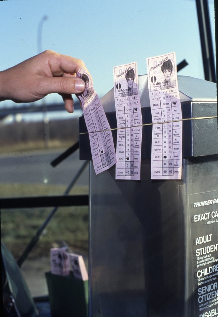 A selection of tickets held on to a podium by an elastic band