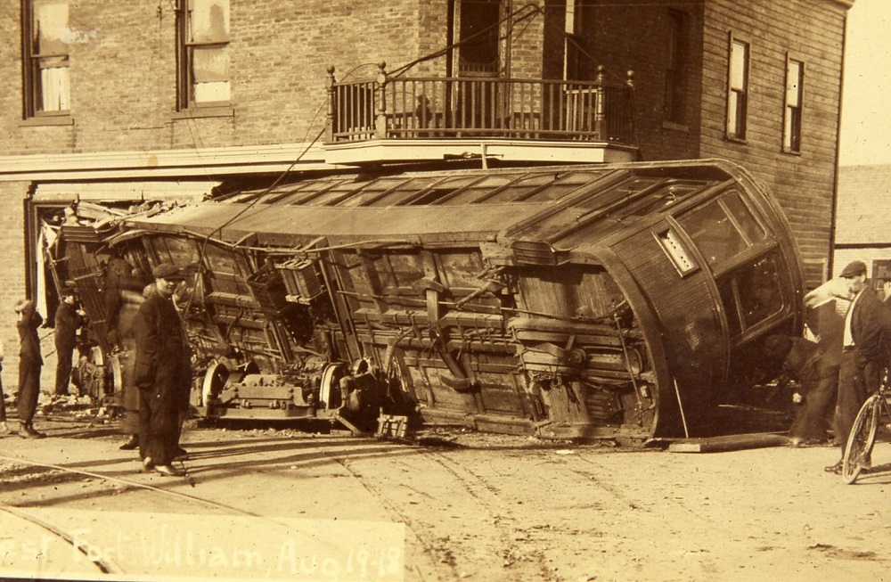 an overturned street car sitting on its side on the road